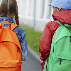 two students from behind wearing backpacks