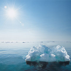 sun beating down on lone iceberg