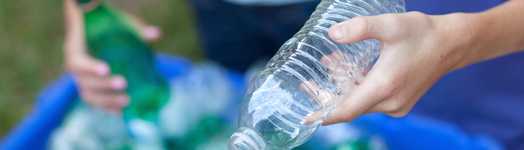 putting plastic bottle in recycle bin