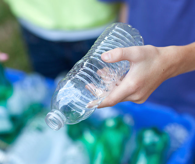 putting plastic bottle in recycle bin